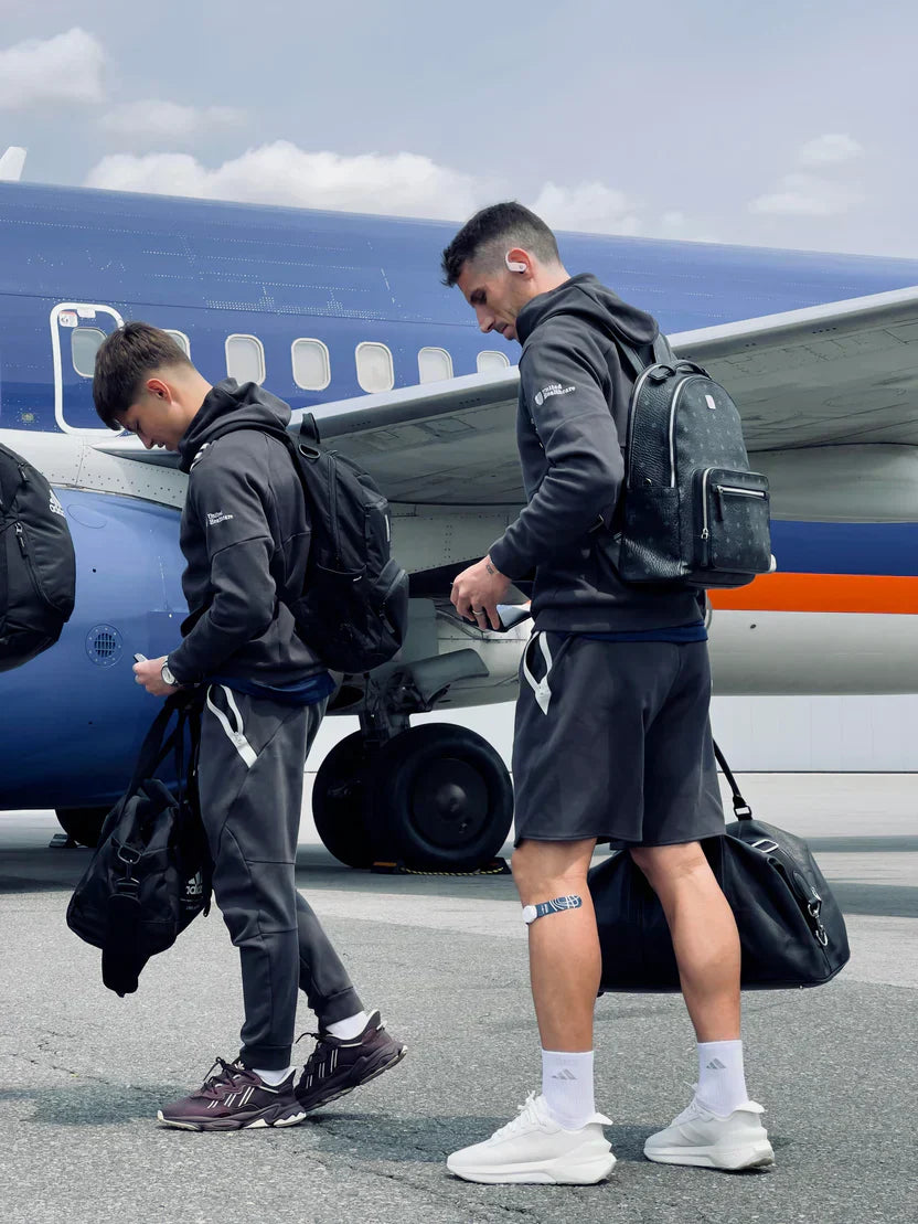 Athletes boarding a plane wearing Firefly, designed to improve blood flow and reduce fatigue for a smooth journey ahead.