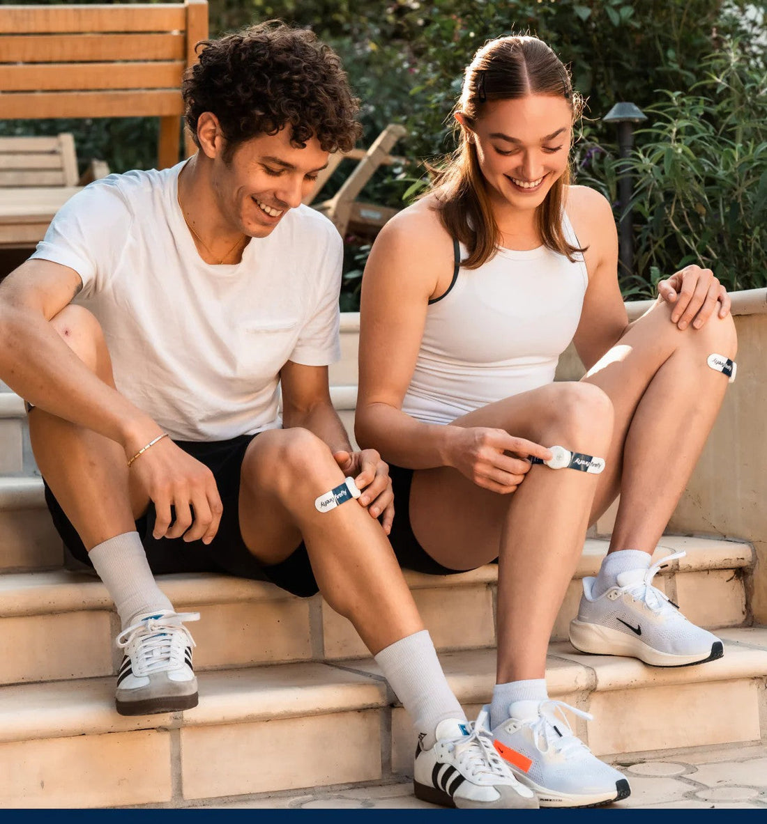 Two athletes wearing Firefly recovery devices on their legs after training to support muscle recovery and circulation.