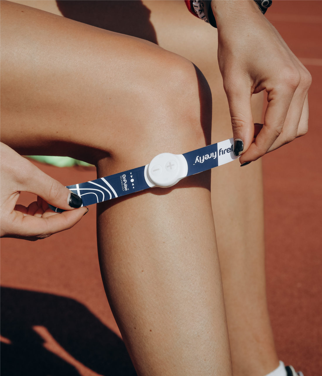 Runner wearing a Firefly neuromuscular recovery device on the lower leg to support circulation and post-run recovery.