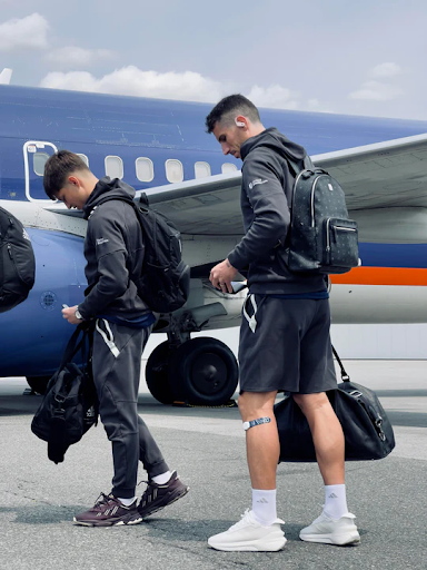 Athlete wearing Firefly recovery devices on both lower legs while traveling before a competition.